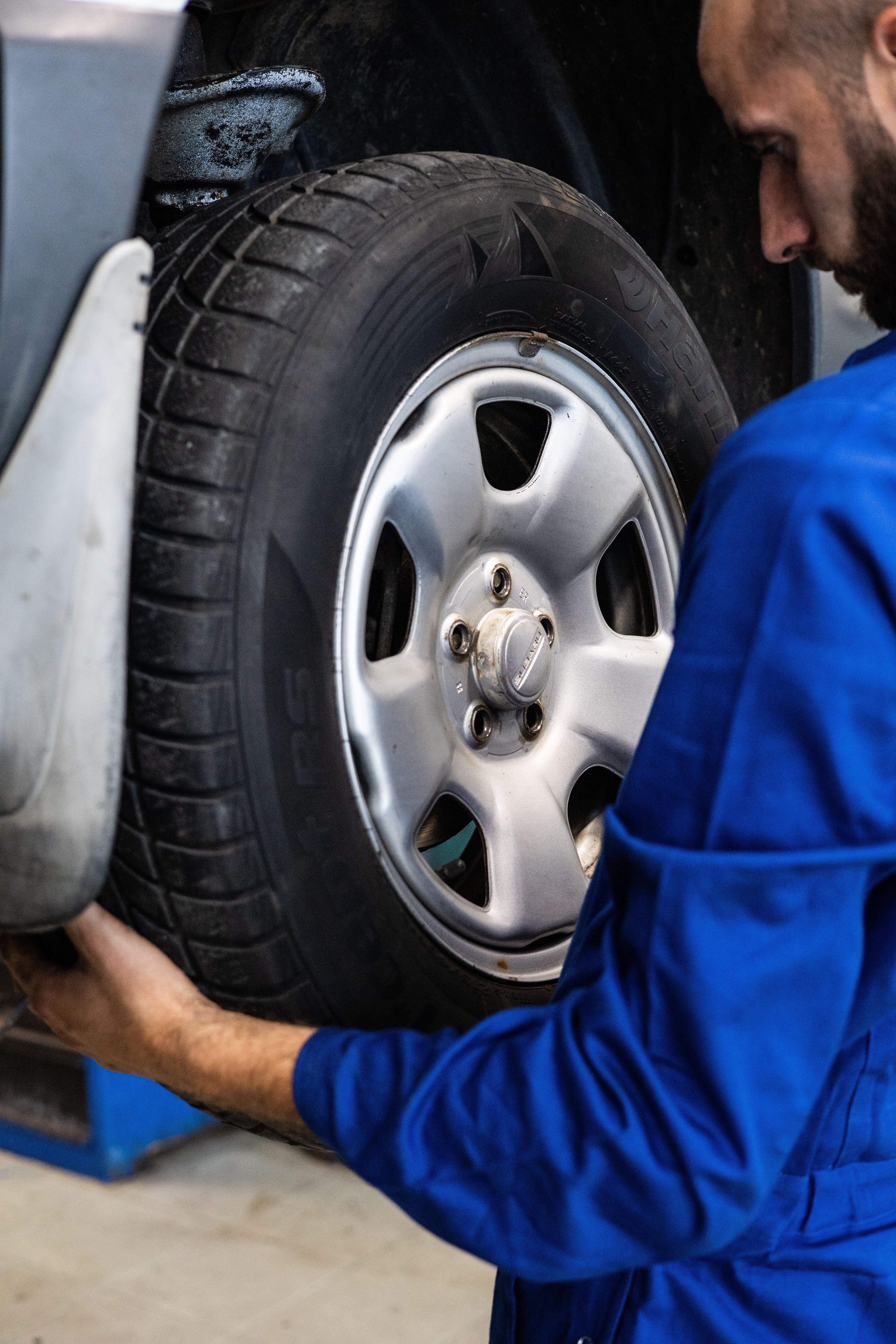 Professional tire technician at work in service bay